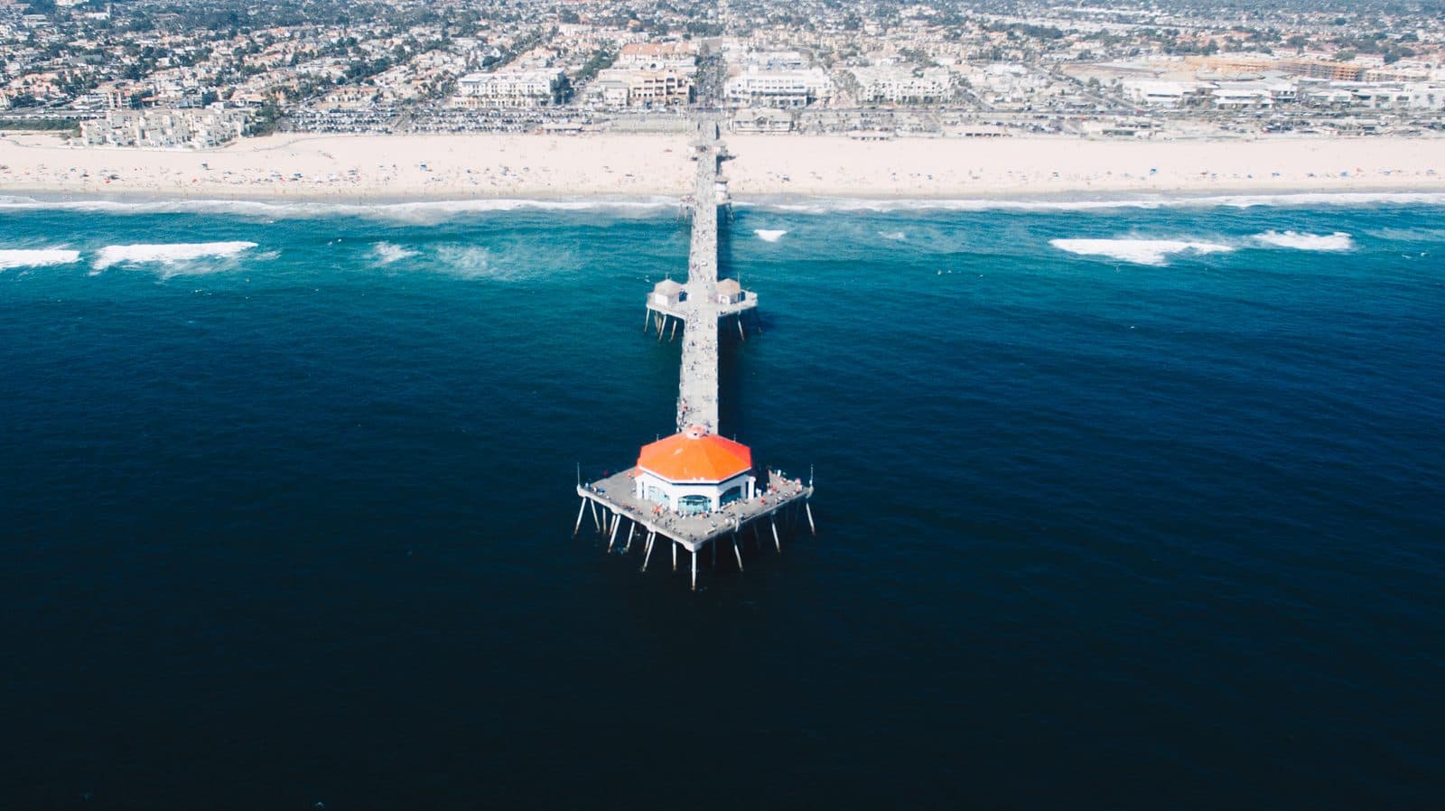 A pier and a long stretch of shoreline seen from above